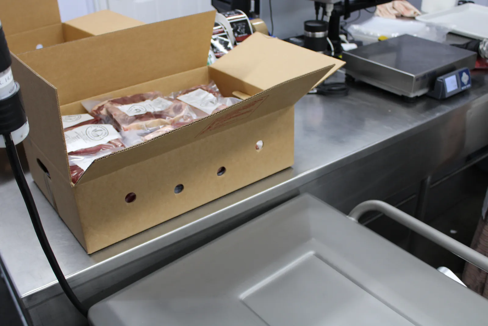 A bundle box of labeled, vacuum-sealed packs at the butcher shop